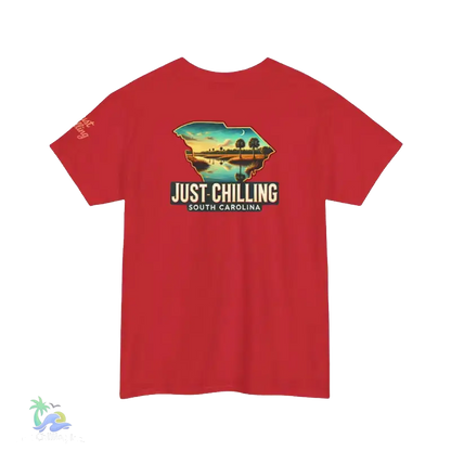 A red t-shirt with a graphic design depicting a scenic landscape, including a lake, mountains, and a sunset. The text on the t-shirt reads "Just Chilling South Carolina".