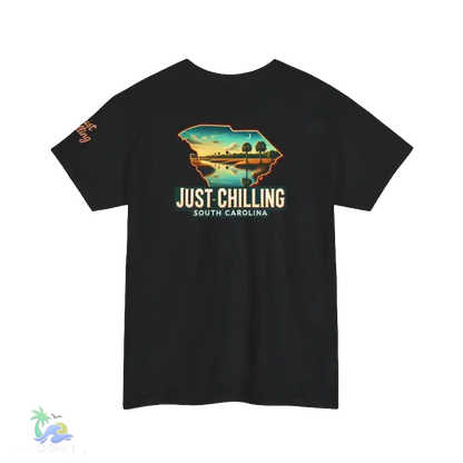 A black t-shirt with a graphic design depicting a scenic landscape with a body of water and palm trees. The text on the t-shirt reads "Just Chilling South Carolina".
