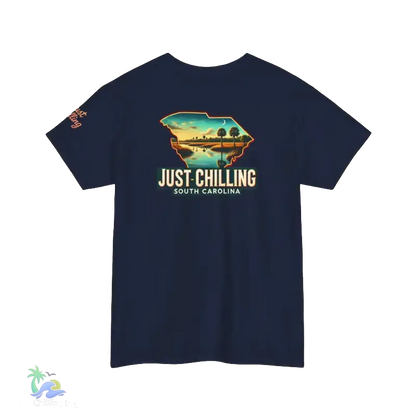 A navy blue t-shirt with a graphic design depicting a scenic landscape with palm trees and a body of water, along with the text "Just Chilling South Carolina".