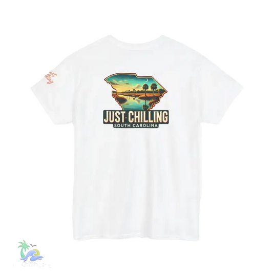 A white t-shirt with a graphic design depicting a scenic landscape with a body of water and palm trees. The text on the t-shirt reads "Just Chilling South Carolina".