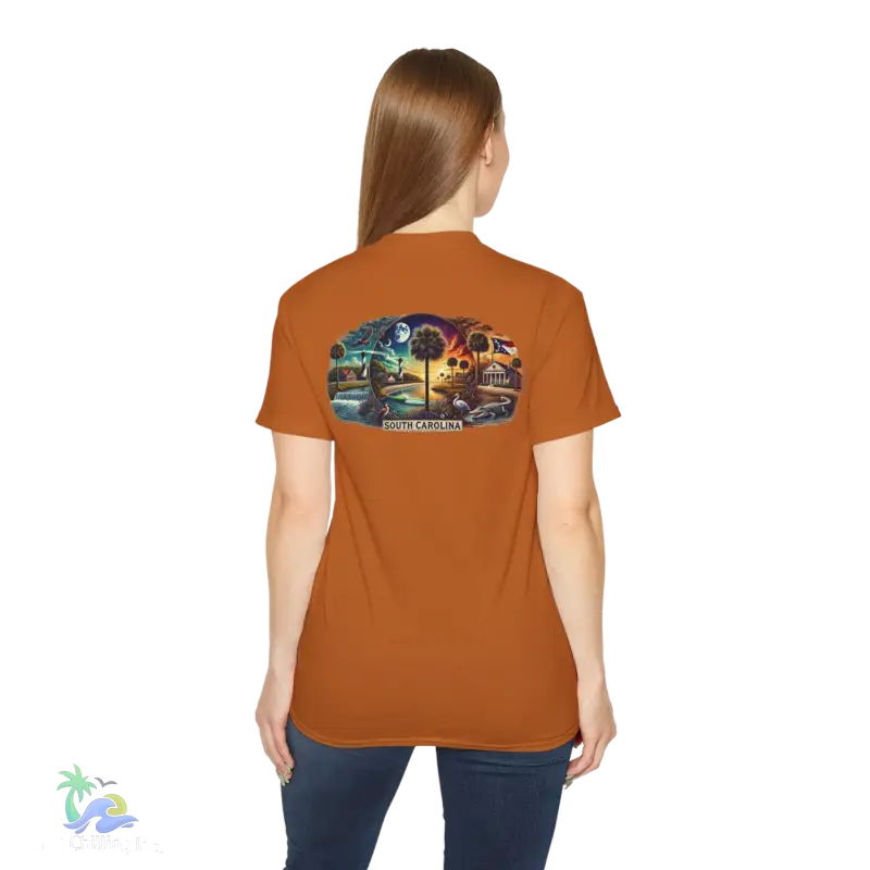 a woman wearing an orange t - shirt with a picture of a train on it