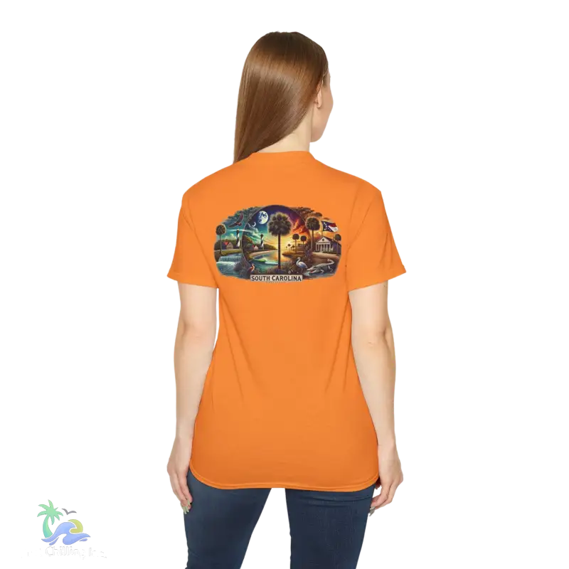 a woman wearing an orange shirt with a picture of a train on it