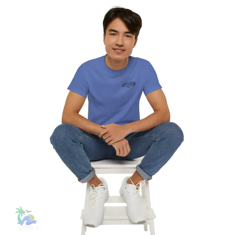 a man sitting on top of a white step stool