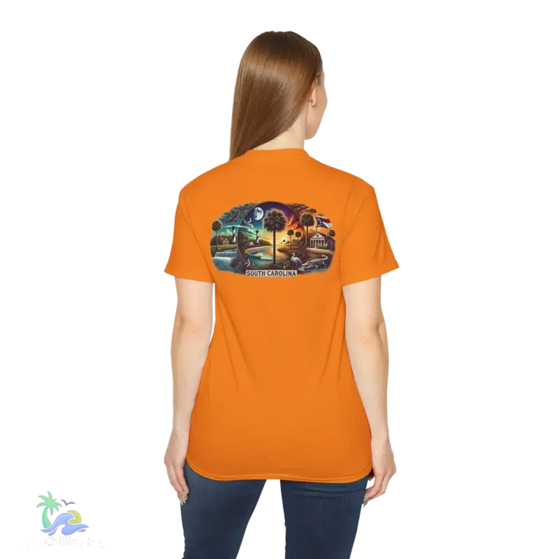 a woman wearing an orange shirt with a picture of a train on it