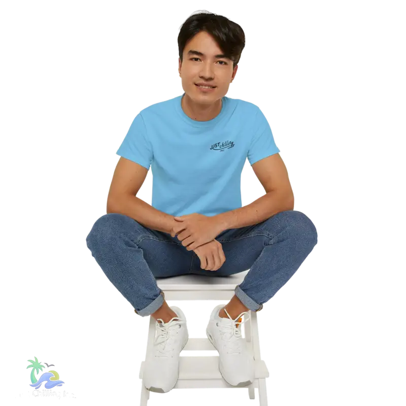 a man sitting on top of a white step stool